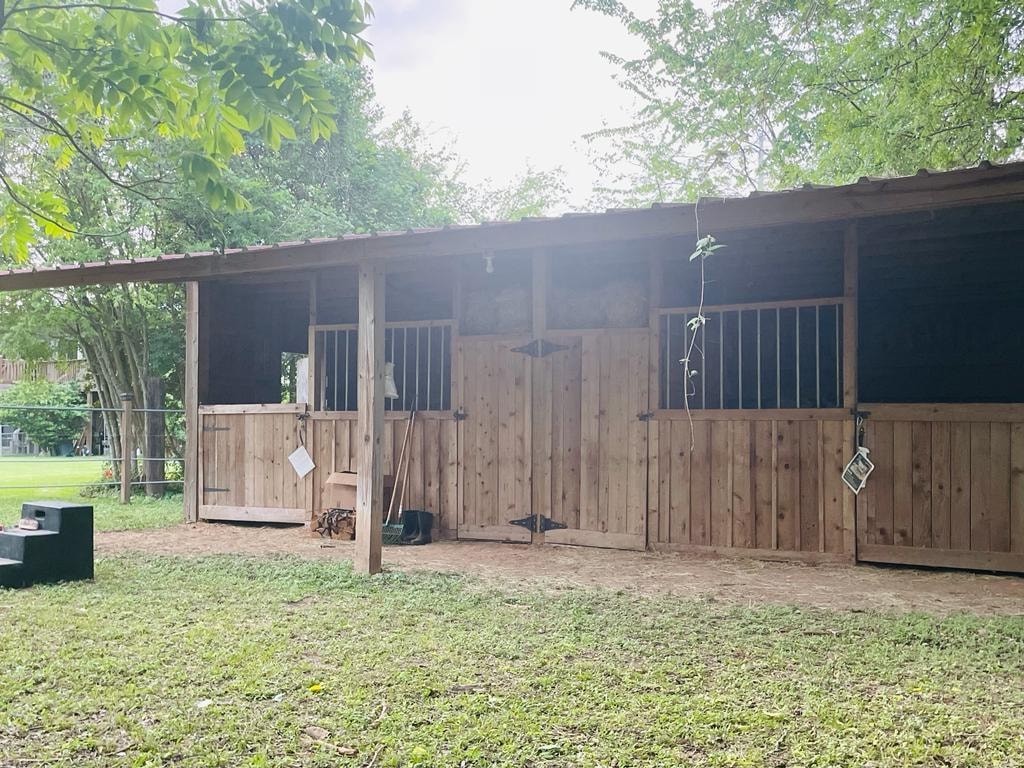 Wooden horse stable with stall doors at Sugar Land RV Park