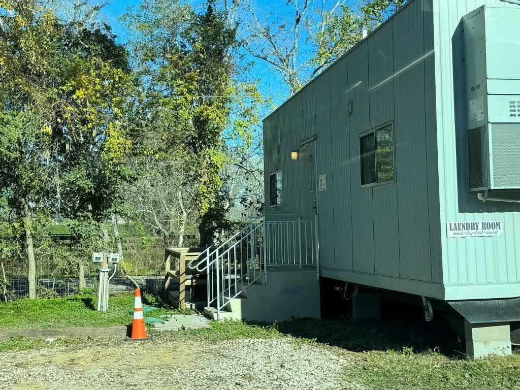 Laundry Room building exterior with staircase and Laundry Room sign at Sugar Land RV Park