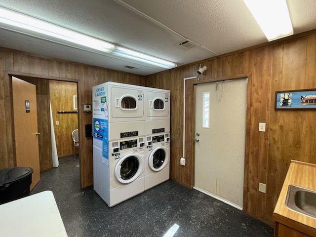 Laundry room with stacked washers and dryers at Sugar Land RV Park