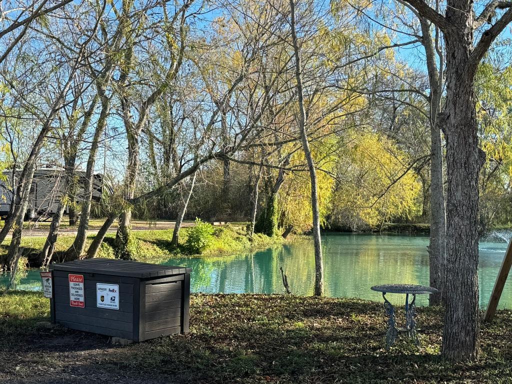 Package delivery box beside the pond with autumn trees at Sugar Land RV Park