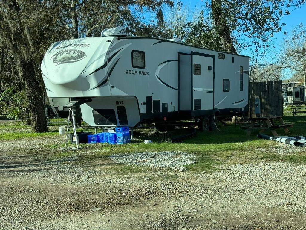 Forest River Wolf Pack fifth-wheel RV parked on gravel at Sugar Land RV Park